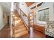 Elegant wooden staircase with wrought-iron railing and hardwood floors at 415 Bruce Rd, Douglasville, GA 30134