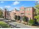 Beautiful brick building featuring manicured landscaping, balconies, and awning covered front doors at 351 Washington Ne Ave # 302, Marietta, GA 30060