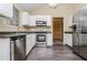 Modern kitchen featuring stainless steel appliances, granite countertops, and wood floors at 254 Cobblestone Ln, Mcdonough, GA 30252