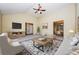 Open living room featuring vaulted ceiling, fan, tv, and access to dining area at 254 Cobblestone Ln, Mcdonough, GA 30252