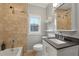 Cozy bathroom featuring tile shower, updated vanity, and ample lighting at 1196 Oleander Nw St, Atlanta, GA 30314