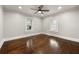 Spacious bedroom with hardwood floors, ceiling fan, and natural light from two windows at 1196 Oleander Nw St, Atlanta, GA 30314