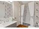 Bathroom with marble tile, a built-in tub, and peacock wallpaper at 6220 Vickery Creek Rd, Cumming, GA 30040