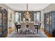 Formal dining room with dark wood table and patterned wallpaper at 6220 Vickery Creek Rd, Cumming, GA 30040