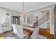 Elegant dining room features a large wood table, chandelier, and hardwood floors at 6220 Vickery Creek Rd, Cumming, GA 30040