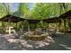 Stone fire pit with covered seating area at 6220 Vickery Creek Rd, Cumming, GA 30040