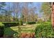 Landscaped front yard with lush green grass, manicured hedges, and stone pathway at 6220 Vickery Creek Rd, Cumming, GA 30040