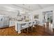 Bright kitchen boasts a large island, white cabinets, and hardwood floors at 6220 Vickery Creek Rd, Cumming, GA 30040