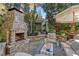 Cozy patio with fireplace, seating area, and pergola for shade at 6220 Vickery Creek Rd, Cumming, GA 30040