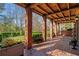 Brick porch with wooden ceiling beams and view of backyard at 6220 Vickery Creek Rd, Cumming, GA 30040