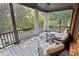 Relaxing covered porch with seating and outdoor rug at 6220 Vickery Creek Rd, Cumming, GA 30040