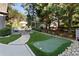 Landscaped backyard featuring a putting green and stone pathway at 6220 Vickery Creek Rd, Cumming, GA 30040