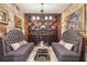 Elegant wine cellar boasts custom wooden shelving and seating area at 6220 Vickery Creek Rd, Cumming, GA 30040