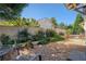 Landscaped backyard with gravel pathway, brick wall, and lush greenery at 6715 Berkley Rd, Cumming, GA 30040