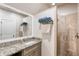 Bathroom with granite countertop, a large mirror, and a walk-in shower at 6715 Berkley Rd, Cumming, GA 30040