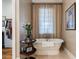 Relaxing bathroom with a freestanding tub and large window at 6715 Berkley Rd, Cumming, GA 30040