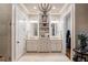 Double vanity bathroom with a chandelier and built-in shelving at 6715 Berkley Rd, Cumming, GA 30040