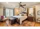 Bright bedroom with a king-size bed and plantation shutters at 6715 Berkley Rd, Cumming, GA 30040