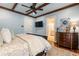 Spacious bedroom with hardwood floors, a ceiling fan, and a large TV at 6715 Berkley Rd, Cumming, GA 30040