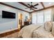 Serene bedroom with hardwood floors and ensuite bathroom access at 6715 Berkley Rd, Cumming, GA 30040