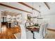 Bright dining room with hardwood floors, chandelier, and view into kitchen at 6715 Berkley Rd, Cumming, GA 30040