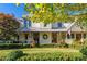 Lovely house with a metal roof, and a nicely landscaped front yard at 6715 Berkley Rd, Cumming, GA 30040