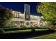 Elegant home at night, illuminated with string lights, and manicured landscaping at 6715 Berkley Rd, Cumming, GA 30040