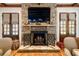 Elegant stone fireplace with a black metal screen and decorative mantle at 6715 Berkley Rd, Cumming, GA 30040