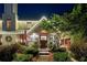 Attractive front door entry with lights and landscaping at night at 6715 Berkley Rd, Cumming, GA 30040