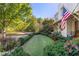 Landscaped front yard with lush greenery and a manicured lawn at 6715 Berkley Rd, Cumming, GA 30040