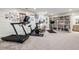 Basement home gym with Peloton bike, treadmill, and ample storage at 6715 Berkley Rd, Cumming, GA 30040