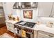 Stainless steel range and hood in a bright white kitchen at 6715 Berkley Rd, Cumming, GA 30040