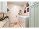 Laundry room with front load washer and dryer, built-in cabinets and granite countertop at 6715 Berkley Rd, Cumming, GA 30040