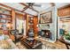 Spacious living room with stone fireplace and wood paneled walls at 6715 Berkley Rd, Cumming, GA 30040