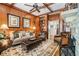 Cozy living room featuring hardwood floors, a fireplace, and built-in shelving at 6715 Berkley Rd, Cumming, GA 30040