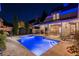 Inviting pool area beautifully lit at night, perfect for summer evenings at 6715 Berkley Rd, Cumming, GA 30040