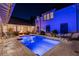 Night view of a refreshing blue pool, surrounded by lush landscaping at 6715 Berkley Rd, Cumming, GA 30040