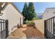 Charming side yard with gravel and plantings next to home's exterior at 6715 Berkley Rd, Cumming, GA 30040