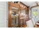 Elegant wine cellar with built-in cabinetry and a large wine refrigerator at 6715 Berkley Rd, Cumming, GA 30040