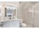 Modern bathroom with a marble vanity, decorative lighting and a tiled glass shower at 6830 Vickery Creek Rd, Cumming, GA 30040