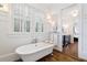 Bathroom with a clawfoot tub and white shiplap walls at 6830 Vickery Creek Rd, Cumming, GA 30040