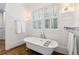 Spa-like bathroom with a freestanding soaking tub and hardwood floors at 6830 Vickery Creek Rd, Cumming, GA 30040