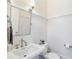 Well-lit bathroom featuring a white vanity, mirror, decorative lighting and wainscoting on the walls at 6830 Vickery Creek Rd, Cumming, GA 30040