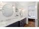 Bathroom with double sinks, marble countertops, and view of bedroom at 6830 Vickery Creek Rd, Cumming, GA 30040