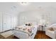 Bedroom with colorful quilt, hardwood floors, and window seating at 6830 Vickery Creek Rd, Cumming, GA 30040