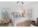 Bedroom with light wood frame bed and plenty of natural light at 6830 Vickery Creek Rd, Cumming, GA 30040