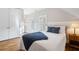 Serene bedroom featuring wood floors, a comfortable bed with blue pillows, and natural light from shuttered windows at 6830 Vickery Creek Rd, Cumming, GA 30040