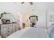 Bright bedroom with white walls, dresser, and a mirror reflecting the bathroom, creating a serene and inviting space at 6830 Vickery Creek Rd, Cumming, GA 30040