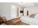 Bright bedroom with hardwood floors, showing the access to the ensuite bath and walk-in closet at 6830 Vickery Creek Rd, Cumming, GA 30040