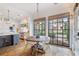 Charming dining area with a round wooden table, modern chairs, and large windows offering natural light at 6830 Vickery Creek Rd, Cumming, GA 30040